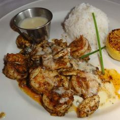 a white plate topped with shrimp and rice