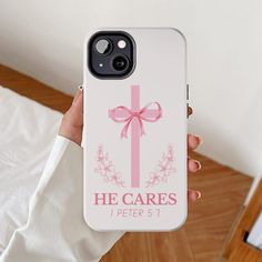 a person holding up a phone case with a pink bow on it that says he cares