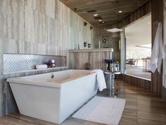 a bathroom with a large bathtub next to a walk in shower