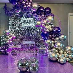 purple and silver balloons are on the table