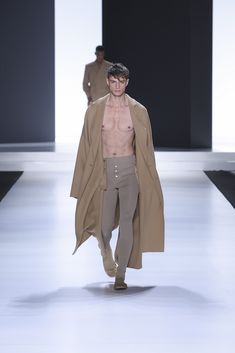 An oversized double cashmere overcoat in beige with peak lapels and dropped shoulders, paired with ribbed knit leggings. Mens Leggings, Knit Leggings