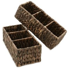 two brown woven baskets sitting next to each other on a white surface with no one in it