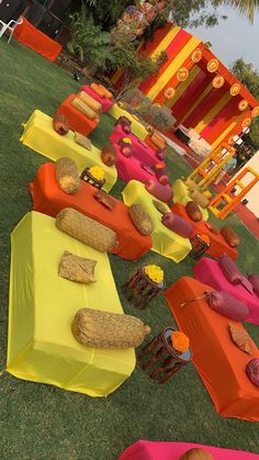 an assortment of food is displayed on colorful tables