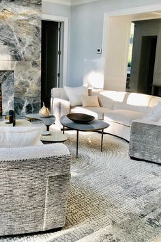 a living room filled with furniture and a fire place in the middle of the room