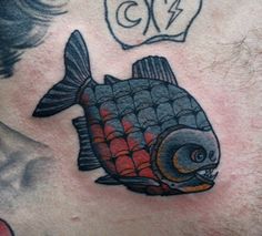 a man with a fish tattoo on his chest and the number twenty seven below it