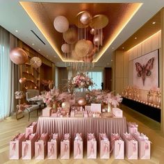 a room filled with lots of pink and gold gift bags on top of a table