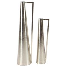 two metal vases sitting next to each other on a white surface, one is tall and the other is short