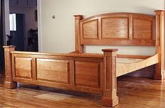 a wooden bed frame sitting on top of a hard wood floor