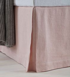 the bed skirt is made with pink linen