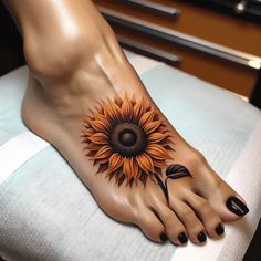 a woman's foot with a sunflower tattoo on it