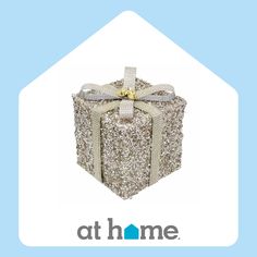 a gift box that has been decorated with silver sequins and gold bow on it