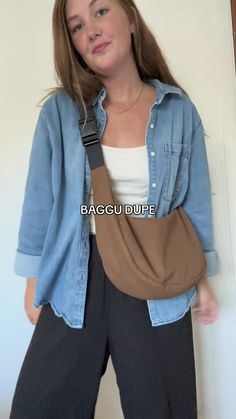 a woman is standing with her back to the camera and wearing a brown baggy purse