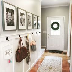 the entryway is decorated with wreaths and pictures on the wall, along with several purses