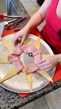 a woman cutting up food on top of a white plate