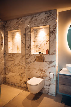 a modern bathroom with marble walls and flooring