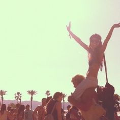 a woman standing on top of another woman's head in front of a crowd