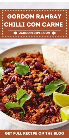 a white bowl filled with chili con carne and tortilla chips on the side