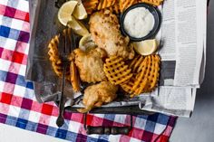 fried fish and waffles with lemon wedges on the side