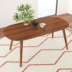 a wooden table sitting on top of a white rug