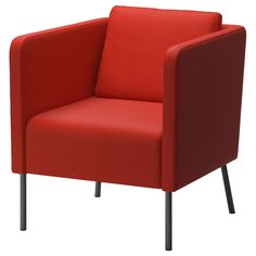 a red chair sitting on top of a white floor next to a black metal frame