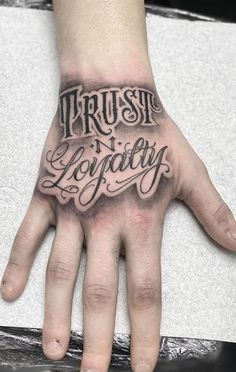 a person's hand with the words trust and loquaty written on it