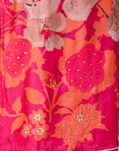 an orange and pink dress with flowers on it