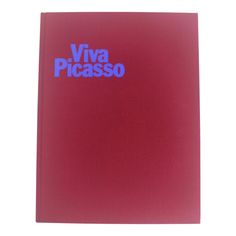 a red book with the words viva picasso in blue on it's cover