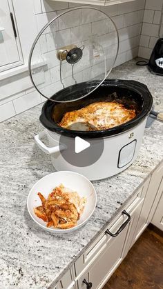 a crock pot with some food in it on a counter top next to a bowl