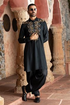 Black afghani kurta with abstract embroidery on the yoke. Paired with a cowl salwar. - Aza Fashions Traditional Long Sleeve Salwar Kameez With Mirror Work, Unstitched Kurta With Mirror Work For Traditional Ceremonies, Eid Salwar Kameez Tunic With Dabka Work, Eid Dabka Work Tunic Kurta, Eid Dabka Tunic Kurta, Eid Dabka Kurta Tunic, Traditional Unstitched Suit With Mirror Work, Traditional Silk Kurta With Mirror Work, Traditional Unstitched Suit With Mirror Work And Long Sleeves