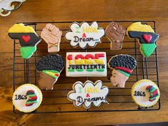 decorated cookies on a cooling rack with words and images for different people's lives