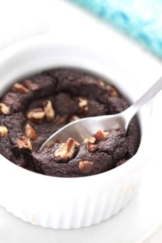 a close up of a spoon in a chocolate cake