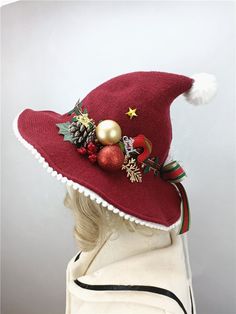 a woman wearing a red hat with ornaments on it