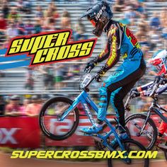 two men riding bikes in front of a crowd at a sporting event with the words supercross on it