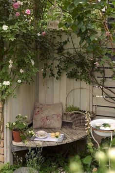 an outdoor bench and table in a garden