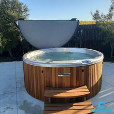 an outdoor hot tub with steps leading up to it