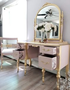 a pink and gold vanity with flowers on it