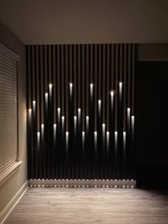 an empty room with lights on the wall and wooden slats in the backround