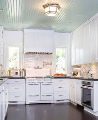 a kitchen with white cabinets and black counter tops is seen in this image from the front view