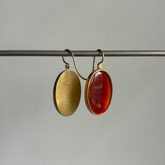 A smooth surface radiates the glowing light captured by fire-orange carnelian in this inviting pair. 18k yellow gold Carnelian, 25.65ctw, 17mm x 24mm (11/16" x 15/16")Earrings hang 1 7/16" from the ear Each earring weighs 6.4g Modern Oval Cabochon Earrings, Yellow Gold Carnelian Jewelry With Polished Finish, Gold Carnelian Jewelry With Polished Finish, Oval Carnelian Jewelry With Polished Finish, Polished Oval Carnelian Jewelry, Gold Carnelian Gemstone Earrings, Modern Orange Oval Jewelry, Oval Carnelian Yellow Gold Jewelry, Modern Red Carnelian Jewelry