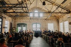 a wedding ceremony in an old building with string lights