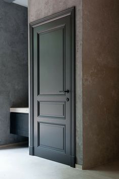 an open door in a room with concrete walls