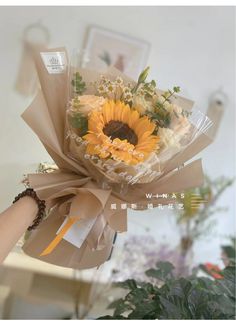 a bouquet of sunflowers wrapped in brown paper