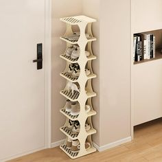 a tall white shelf filled with books next to a wall mounted bookcase in a living room