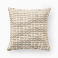 a beige and white pillow on a white background