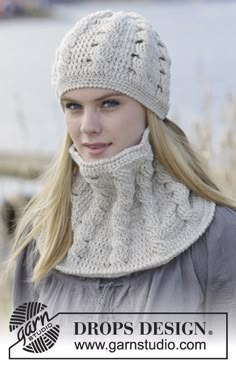 a woman wearing a white knitted hat and scarf with an open cowl around her neck