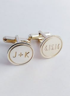 two cufflinks with the initials j - k and f - k on them