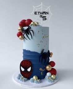 a spiderman themed birthday cake with red, white and blue frosting on top