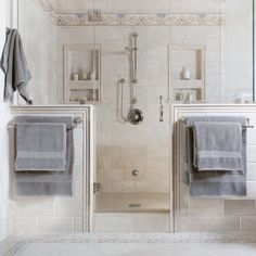 two towels are hanging on the wall next to each other in front of a shower