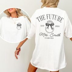 Did you recently get engaged?  This custom FUTURE MRS Comfort Colors® t-shirt is the perfect way to show your excitement for your newly engaged status.  The addition of your future last name makes this engagement tee extra special.  Buy for yourself or make this an engagement gift, bridal shower gift, or gift for the newly engaged bride-to-be. PLEASE READ THROUGH ALL OF THE FOLLOWING INFORMATION.  IF YOU HAVE FURTHER QUESTIONS, WE ARE HAPPY TO HELP! Welcome to CuratedClothCo.!  Here you can find White Text Print Top For Anniversary, White Letter Print Shirt For Anniversary, Bride Shirt Ideas, Engagement Gifts Newly Engaged, Engaged Shirts, Mrs Shirt, Newly Engaged, Personalized Bride, Engagement Gifts