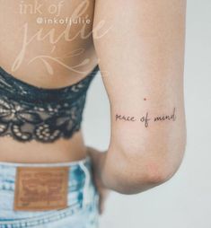 a woman's arm with the words peace of mind tattooed on her left side